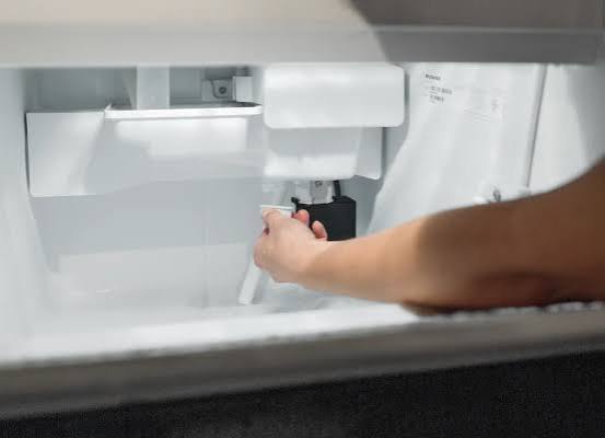 Technician inspecting sanitized ice machine components